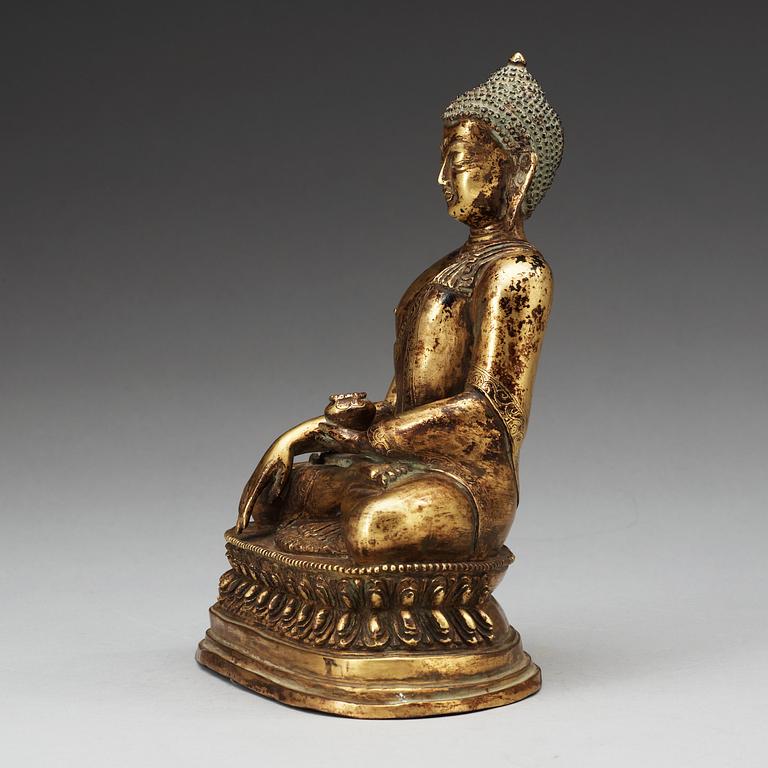 A seated bronze Akshobhya Buddha, late Qing dynasty.