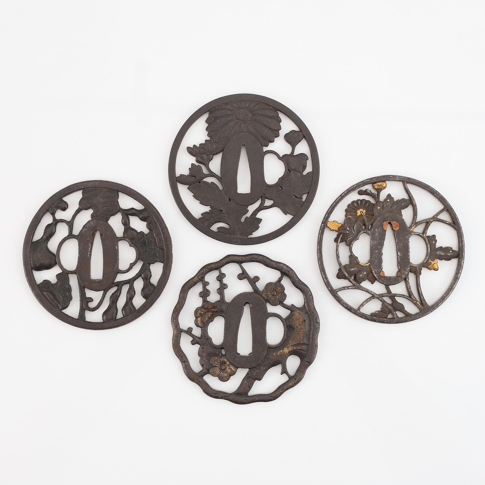 Four iron Tsubas, Edo-period, one signed.