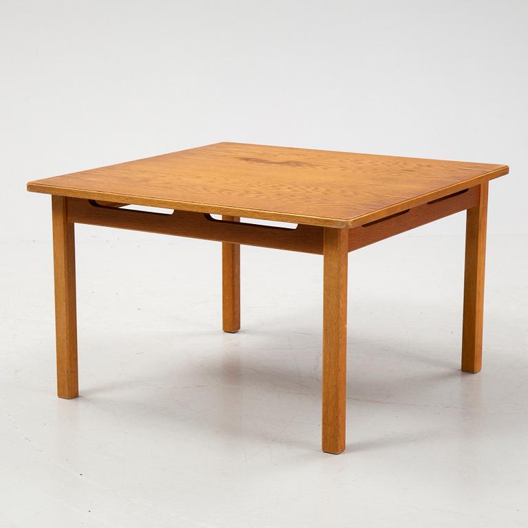 An oak coffee table with a later travertine top.