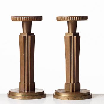 Lars Holmström, a pair of Swedish Grace patinated bronze candlesticks, Arvika, Sweden, 1920's-30's.