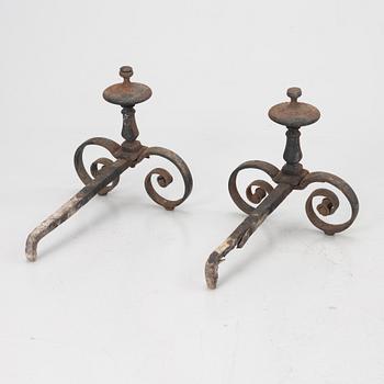 A pair of wrought iron fire dogs.