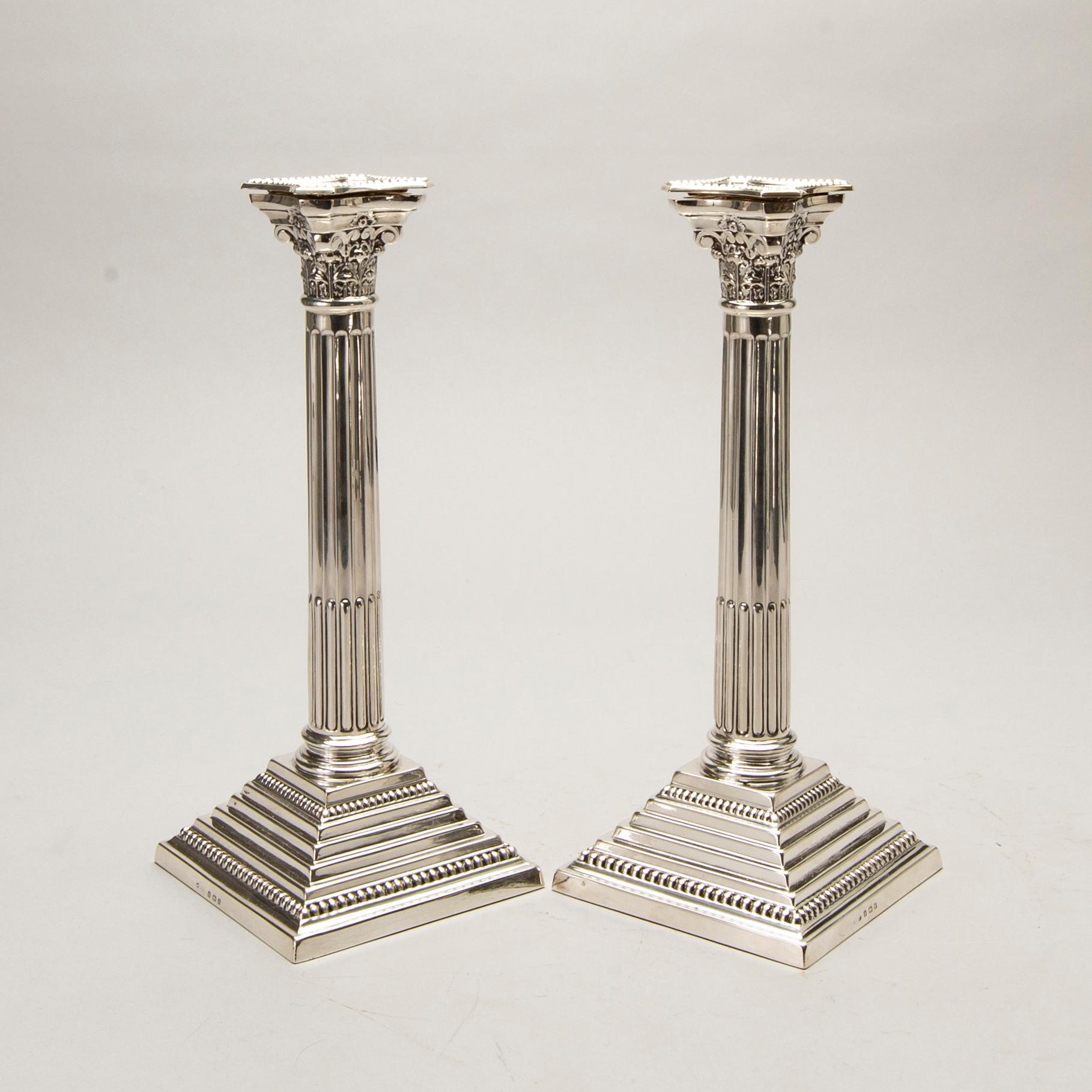 A pair of classical column sterling silver candlesticks Birmingham, 1934, by 'B.G. & Co'.