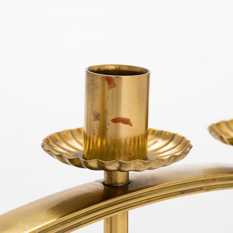 A mid-20th century brass candle holder, Idman.