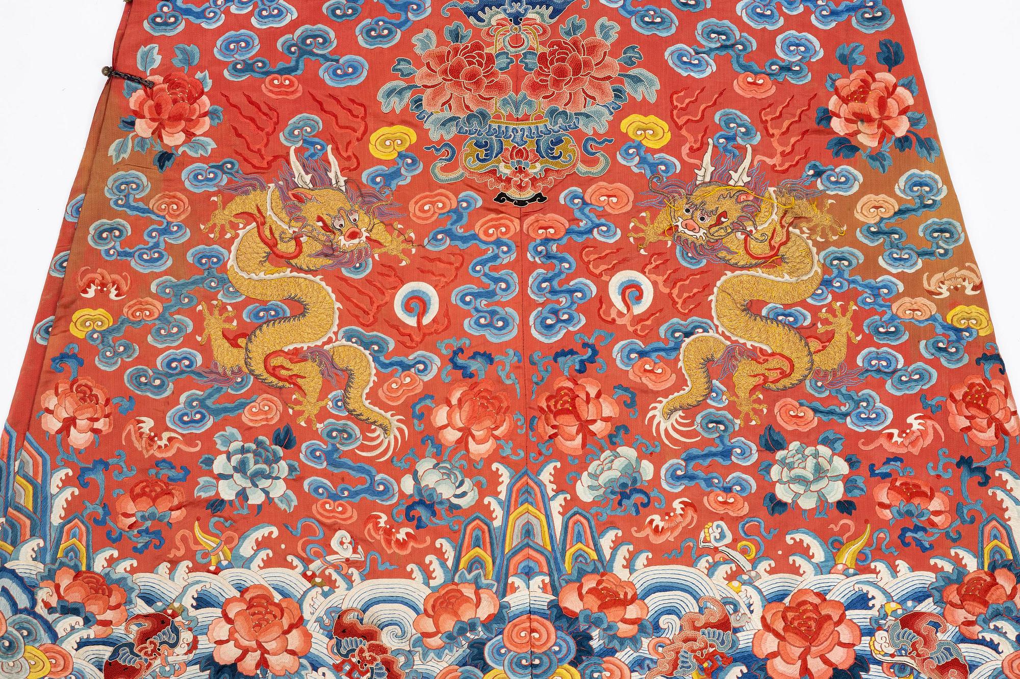 An embroidered red ground five clawed dragon 'female' formal robe, Qing dynasty, 19th century.