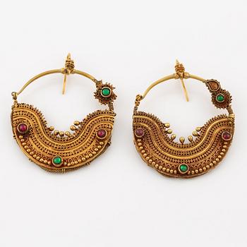 Earrings, India, gold with cabochon-cut red and green stones.