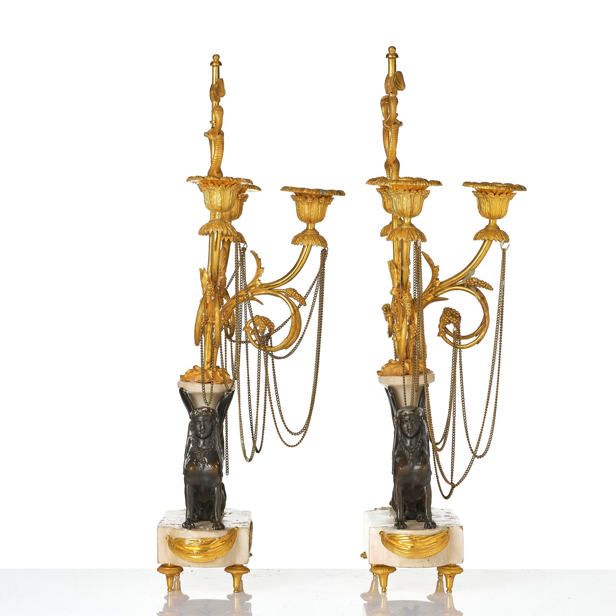 A pair of Louis XVI three lights Candelabra, Parisian works, in the manner of François Rémond, late 18th century.