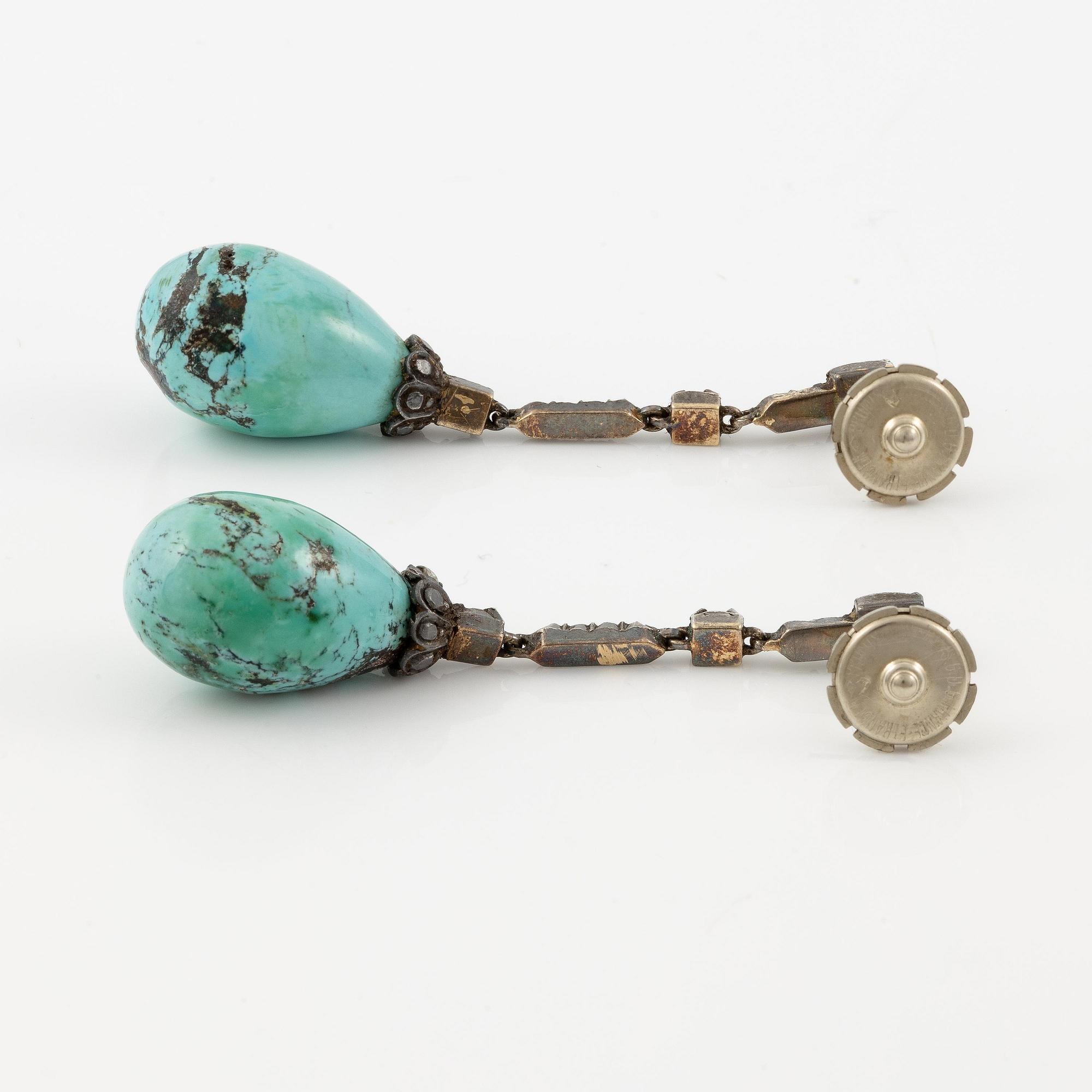 A pair of silver and 18K gold earrings with turquoise drops and rose-cut diamonds.