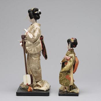 Two Japanese dolls and a box with minitures, 20th Century.