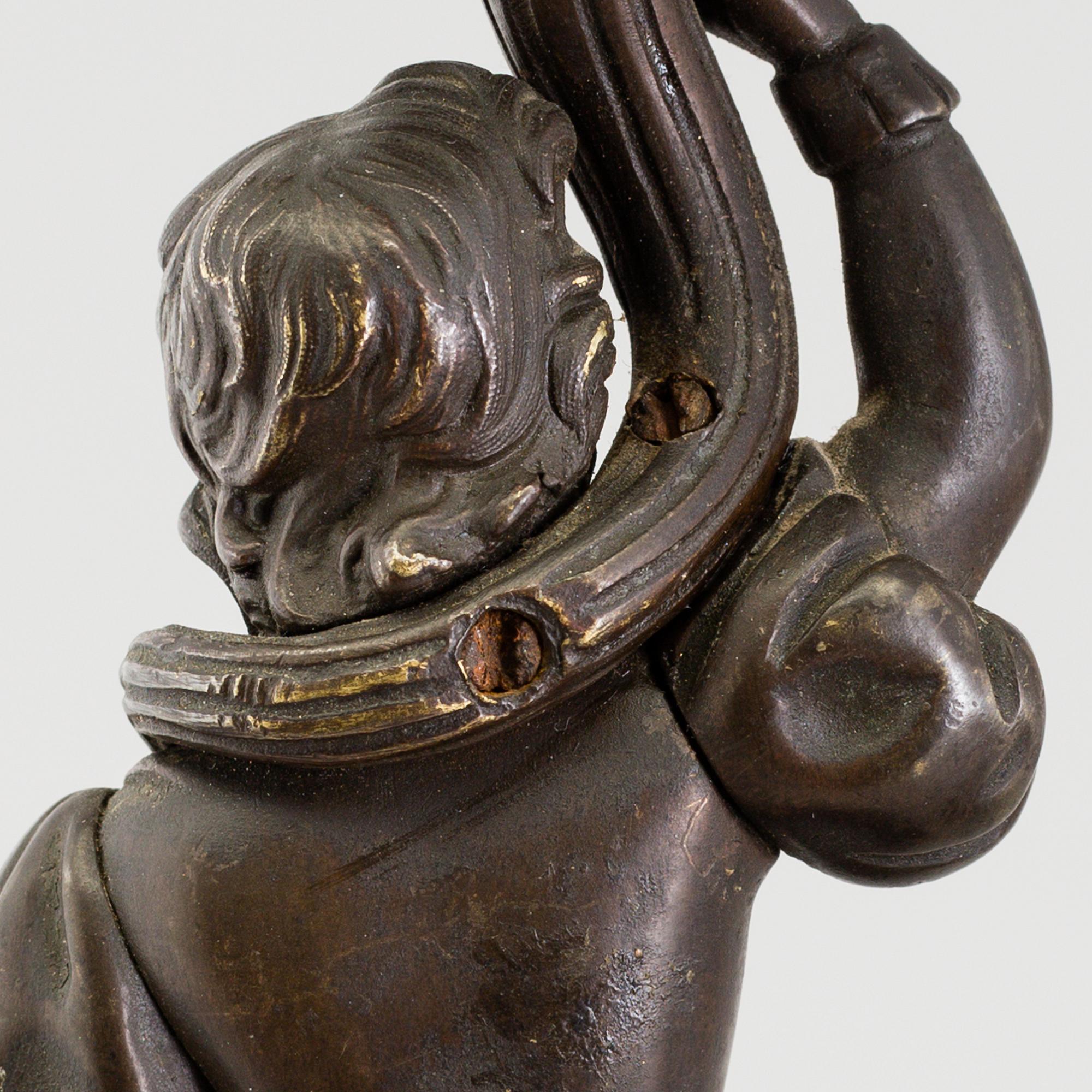 A pair of late 19th century patinated brass candelabra.