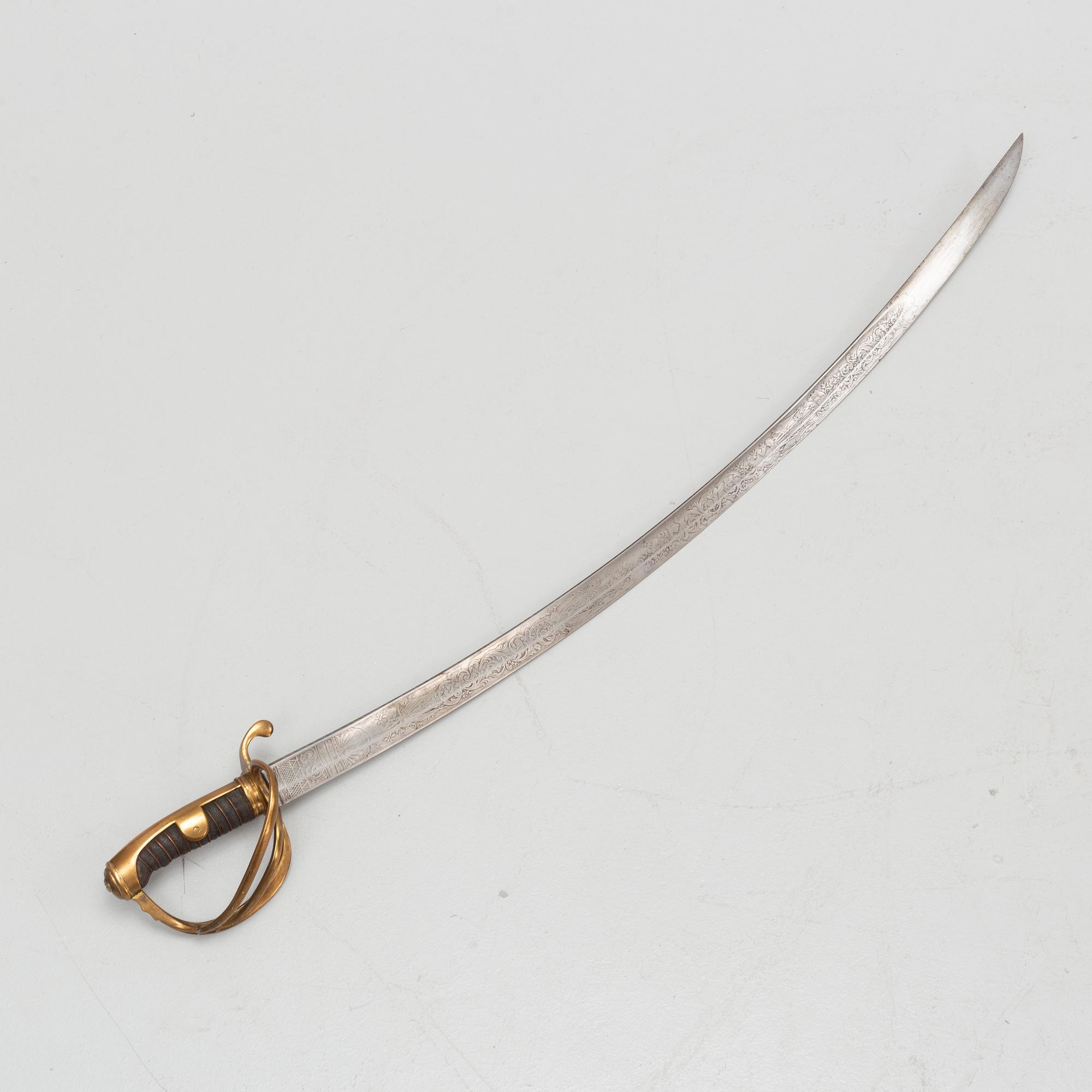 An 19th Century curved officer's sword with etched blade and steel scabbard.