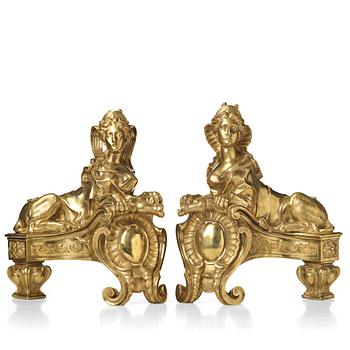 A pair of Louis XV fire dogs, France, mid 18th century, the design of the sphinxes attributed Nicolas Coustou 1658-1733.