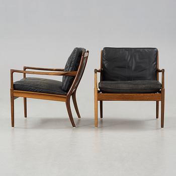 Ib Kofod-Larsen, a pair of palisander and black leather 'Samsö' armchairs, 1960's, for Thysell's, Anderslöv, Sweden.