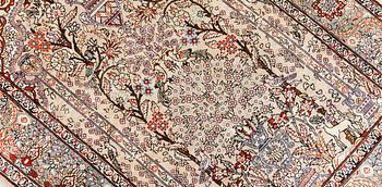 An oriental silk rug, approx. 95 x 63 cm.
