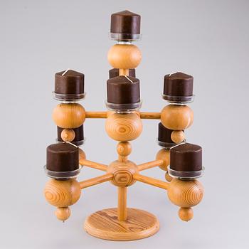 A Finnish wood and glass candelabra, marked Aarikka made in Finland.