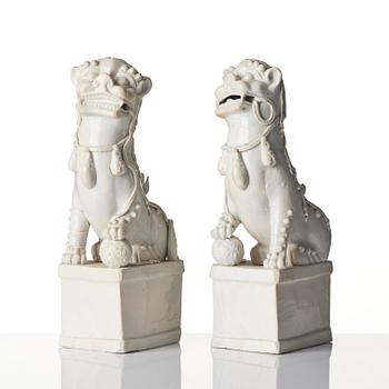 A pair of Chinese blanc de Chine 'Buddhist lion' joss stick holders, Qing dynasty, Kangxi (1662-1722).