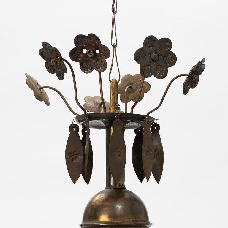 A Baroque style brass chandelier from around the year 1900.