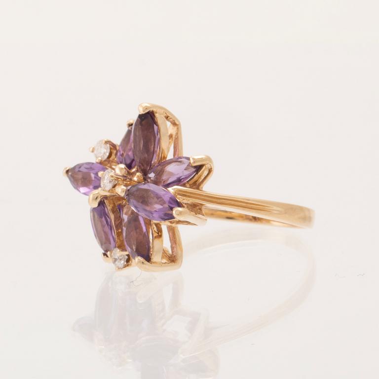 A 14K gold cocktail ring set with round brilliant-cut diamonds and navette-cut amethysts.