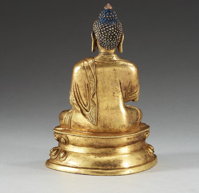 A gilt copper Buddha, presumably Qing dynasty, with Qian Long seven character mark.