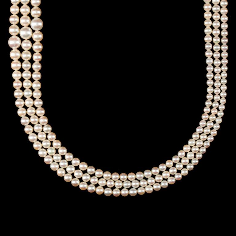 A 3-strand cultured pearl necklace. Clasp set with sapphires. Made in Italy.