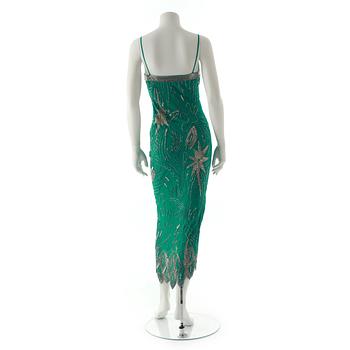 FABRICE, a green silk evening dress with glass bead embellishment.
