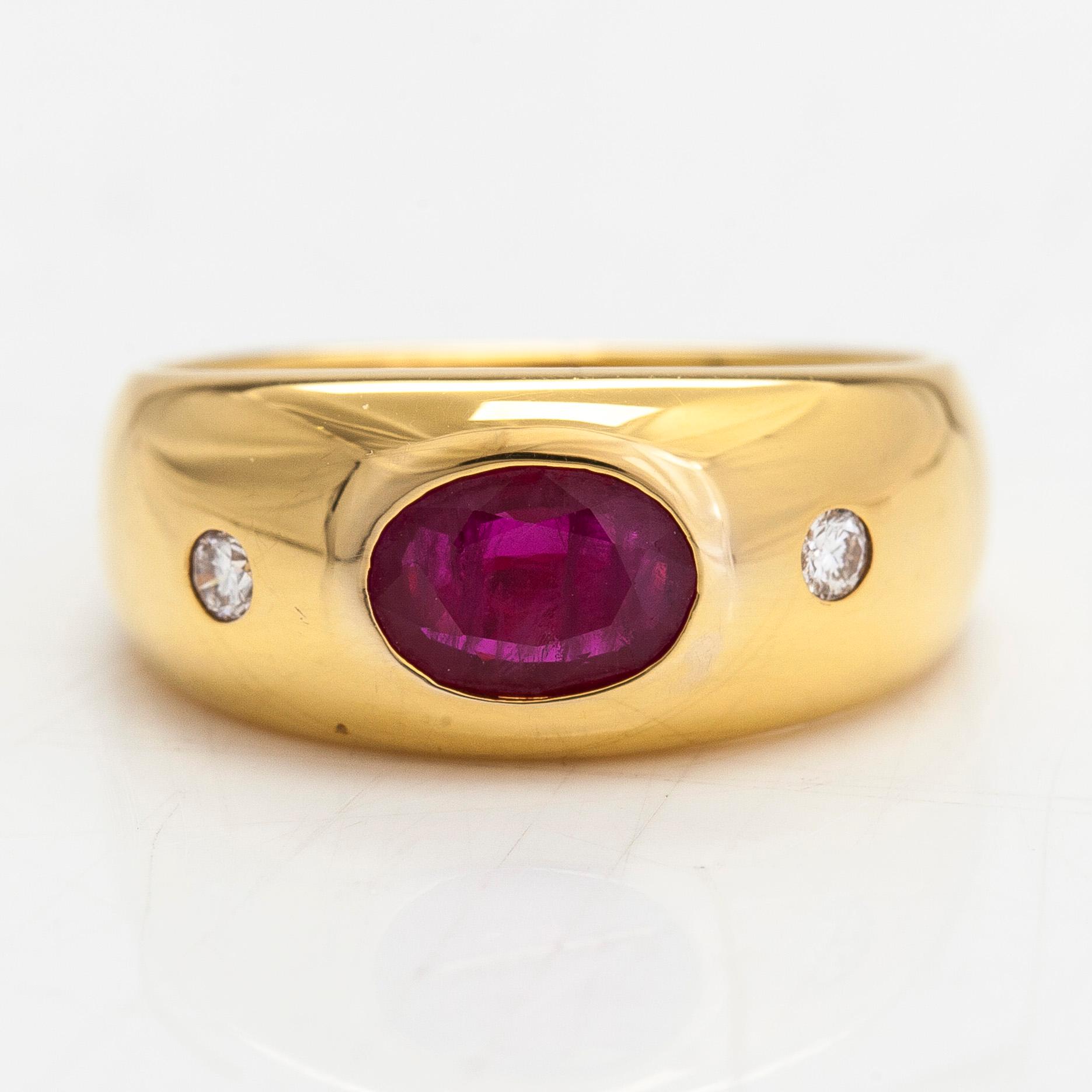 A 14K gold ring, set with an oval-cut ruby and diamonds totaling approx. 0.06 ct. Finland, 1999.
