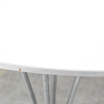 A 'Supercircle' table by Bruno Mathsson & Piet Hein for Fritz Hansen.