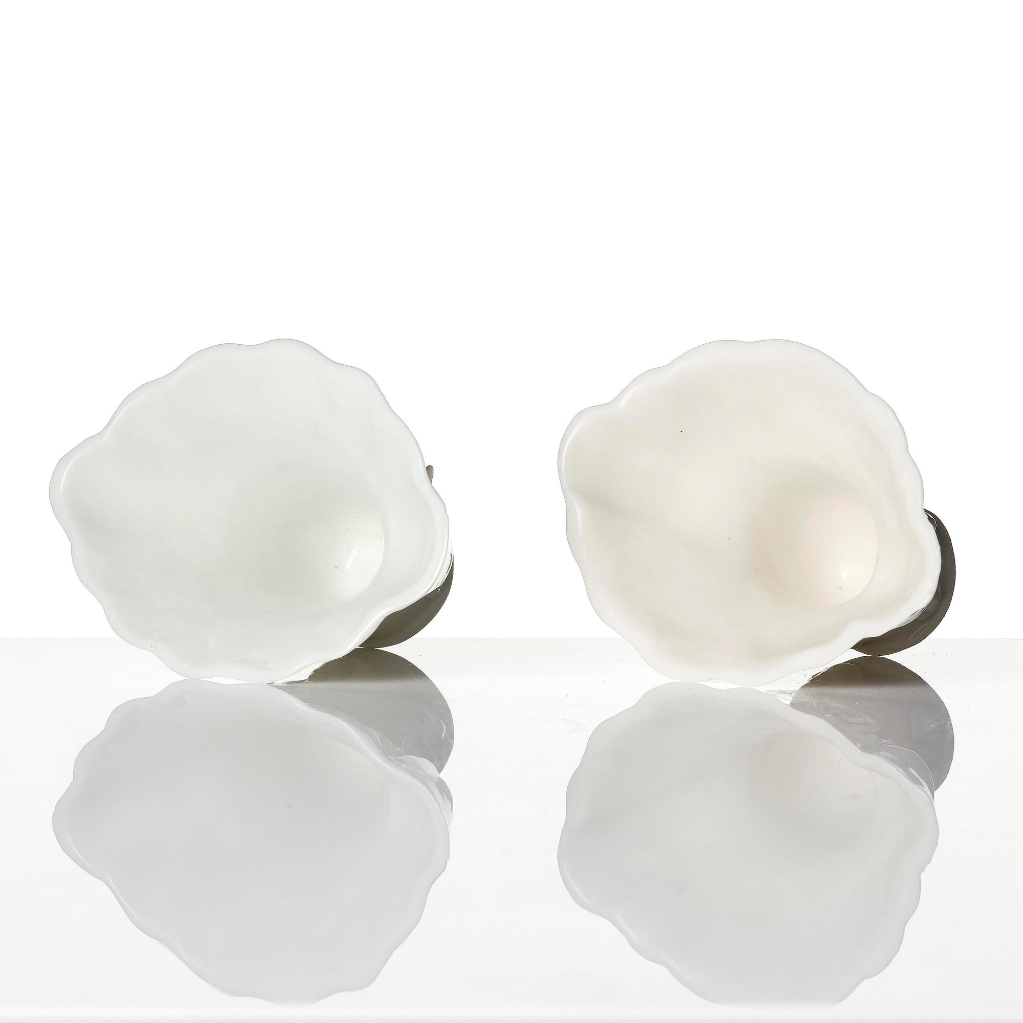 A pair of blanc de chine rhinoceros libation cups, Qing dynasty, Kangxi (1662-1722).