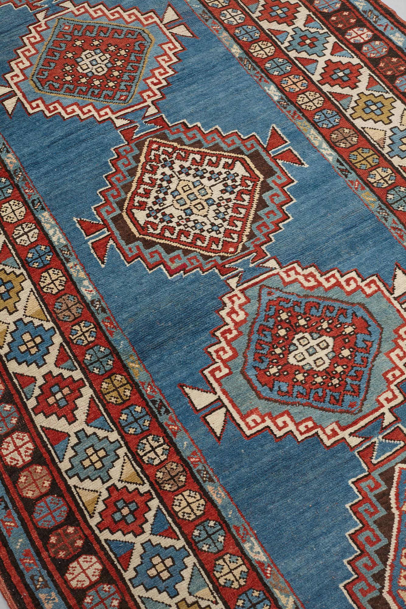 A RUNNER, a semi-antique Caucasian, ca 303,5 x 129,5-140,5 cm (as well as one end with 2,5 cm flat weave).