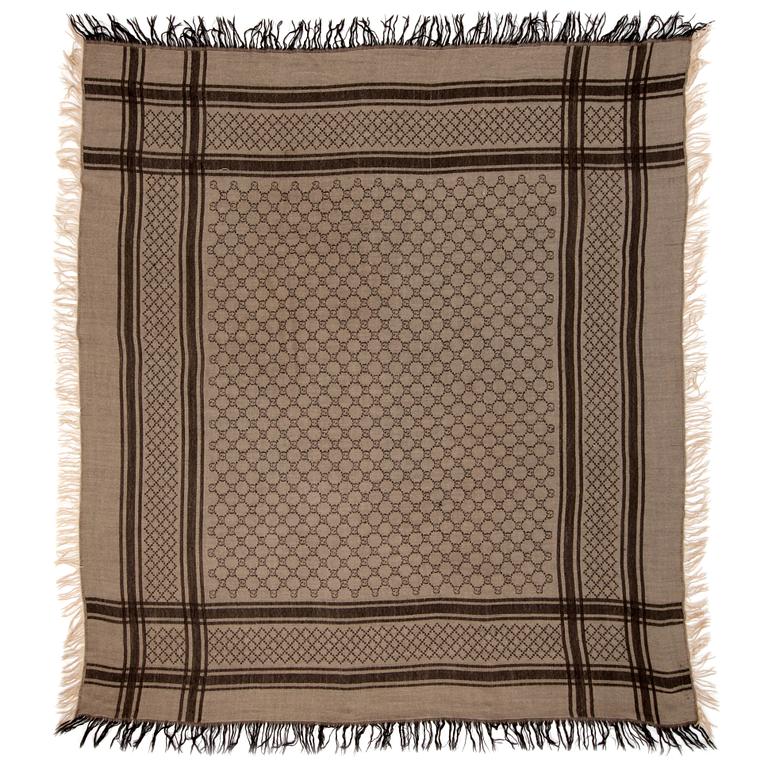 GUCCI, a beige and brown wool and silk shawl.