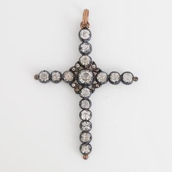 Cross pendant with silver and white stones.