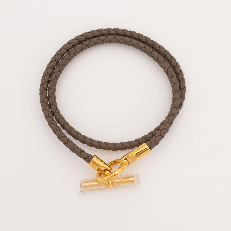 Hermès, a leather bracelet and key chain.