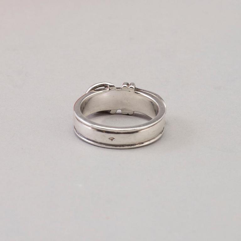 A silver ring by Hermès.