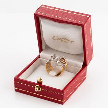 A Cartier "Double C" ring in 18K tri color gold set with round brilliant-cut diamonds.