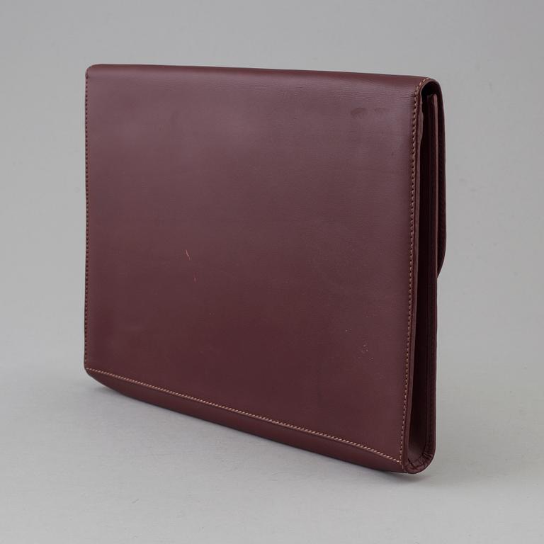 Wine-colored leather briefcase by Cartier.
