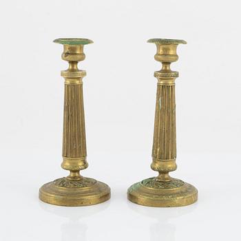 A pair of Empire bronze candlesticks, first half of the 19th Century.