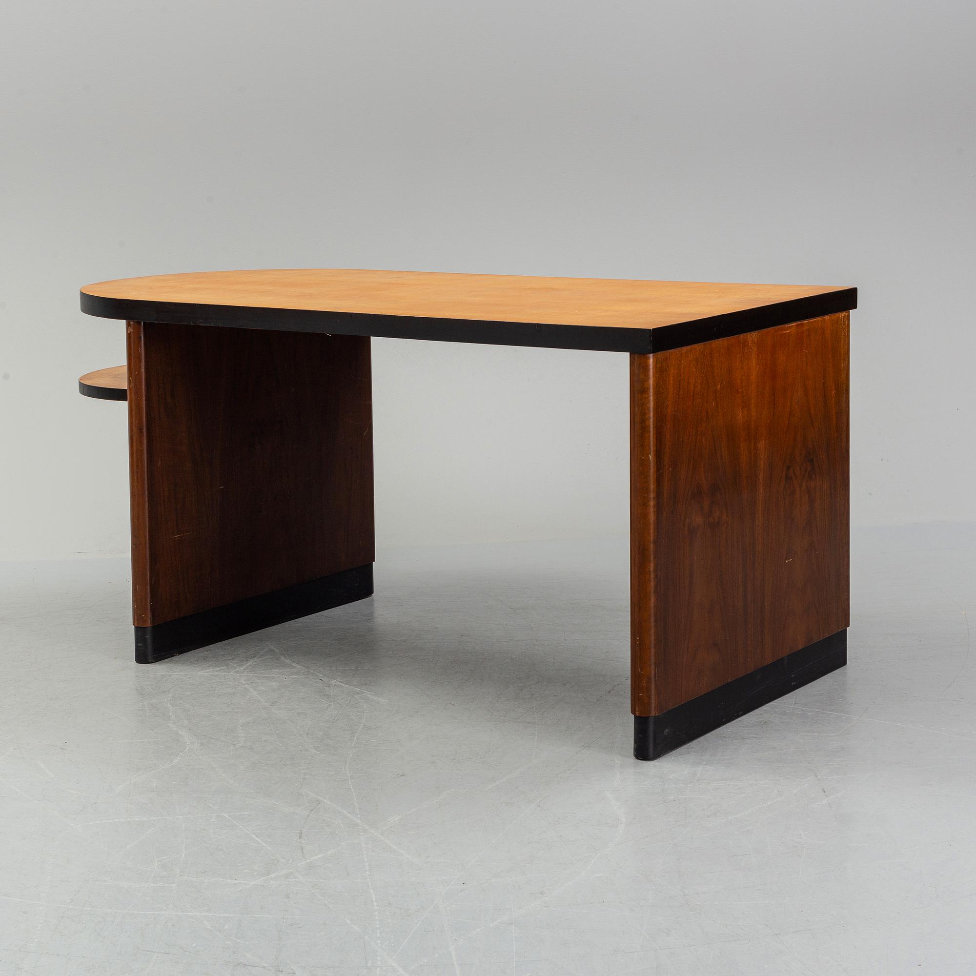 Axel Einar Hjorth, attributed to. A walnut and birch desk, Nordiska Kompaniet, 1930's.