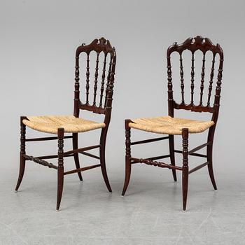 A pair of Chiavari chairs.