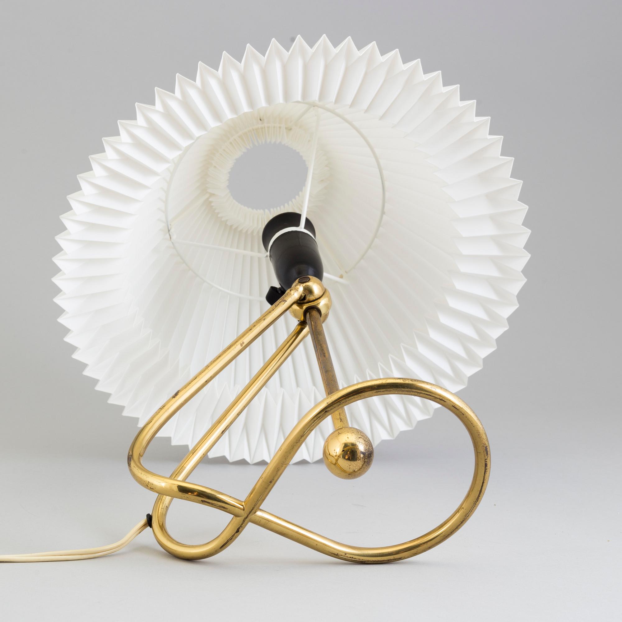 A Le Klint brass table or wall lamp.
