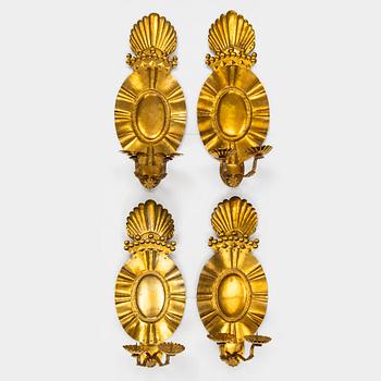 A set of four baroque style brass wall sconces, probably 1950s.