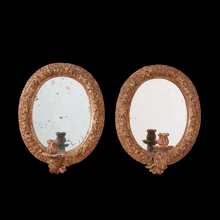 A pair of Swedish Baroque circa 1700 one-light girandole mirrors.