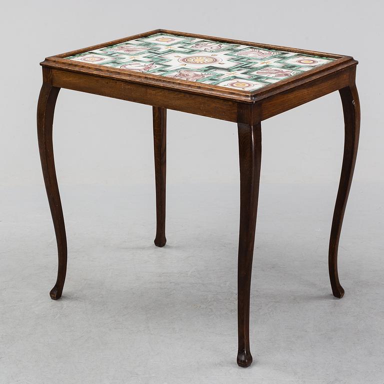 An oak table with glazed tiles by  Anna-Lisa Thomson, S.t Erik, dated 1931.