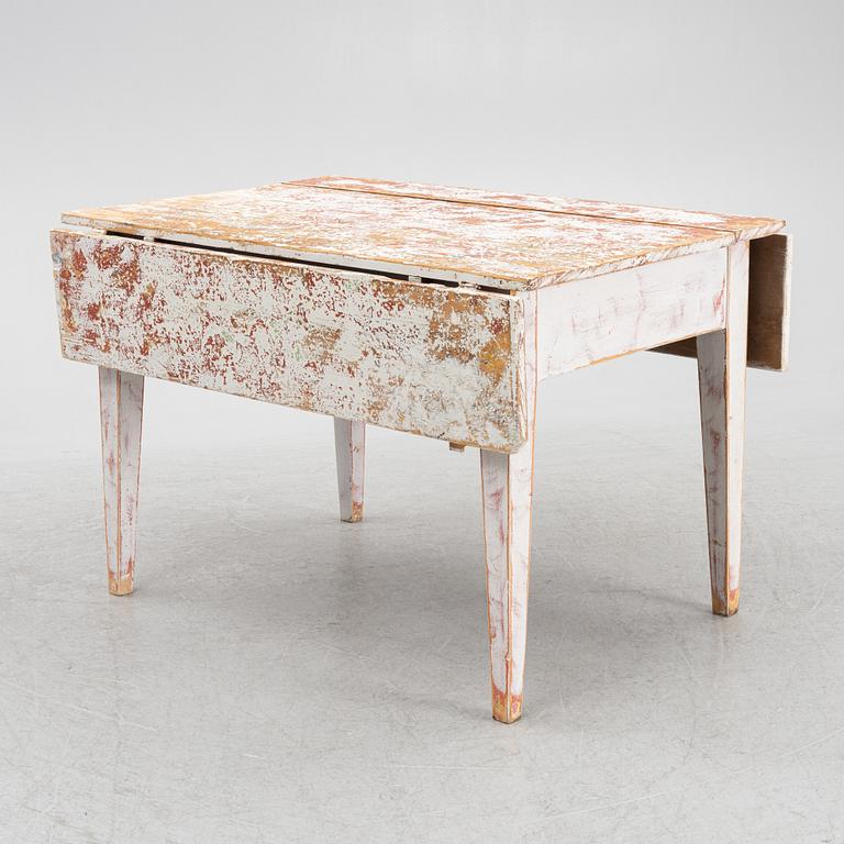 A drop-leaf table, 19th Century.