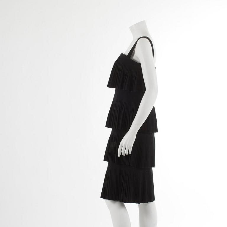 OSCAR DE LA RENTA reportedly, a pleated black cotton frill dress.