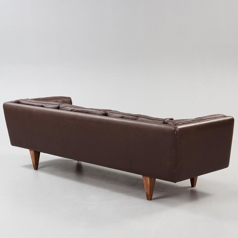 An Illum Wikkelsø three seated brown leather sofa, Michael Laursen, Denmark 1960's.