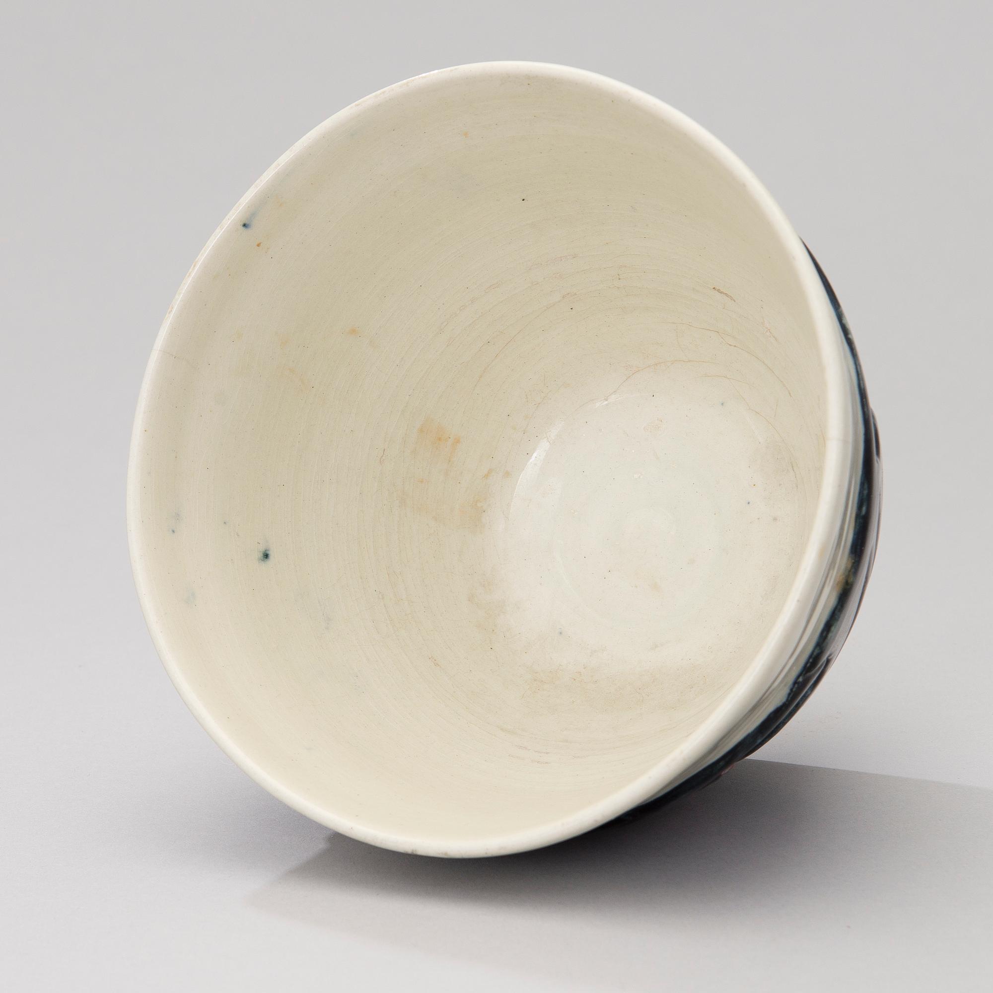 A ceramic bowl signed GT.