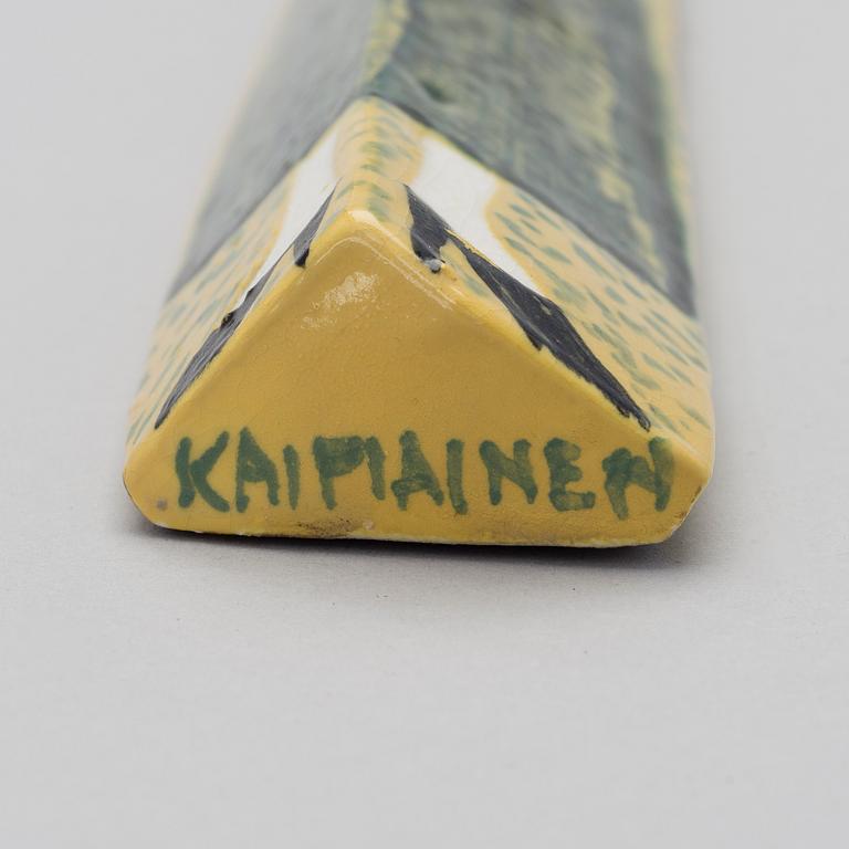 A CERAMIC WALL RELIEF. Small doll. Sign. Kaipiainen.