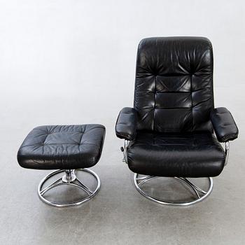 A leather swivel armchair and stool, Söderbergs  1980s.