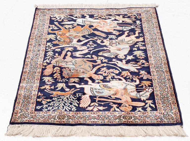 A silk Ghom rug, c. 94 x 62 cm.