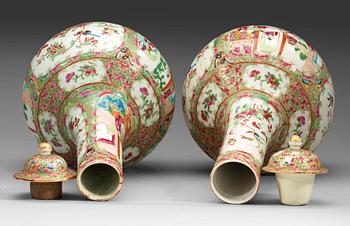 A pair of famille rose Canton vases with covers, Qing dynasty, 19th Century.