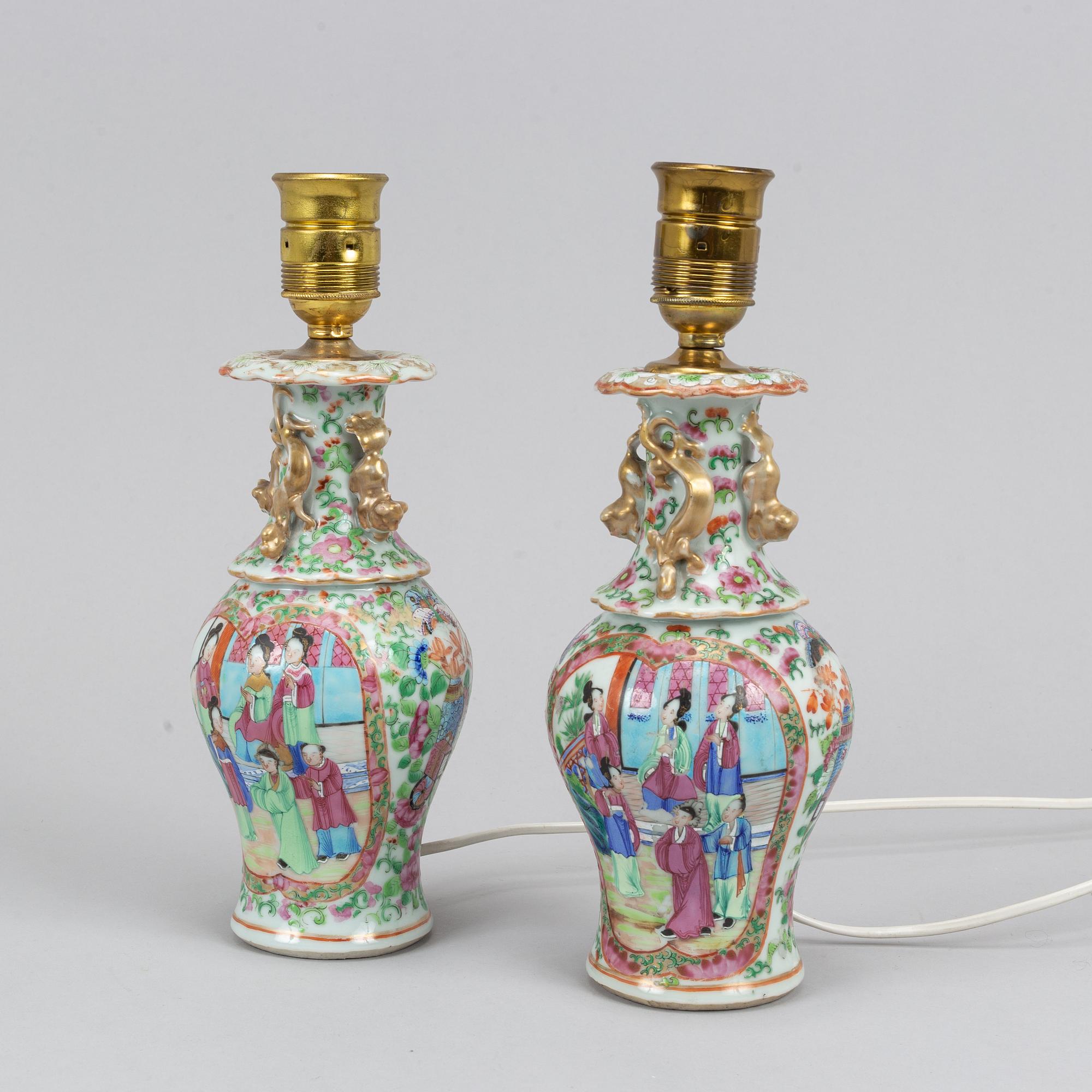 A pair of famille rose Canton table lamps and a vase, Qing dynasty, 19th Century.